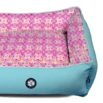 velvet dog bed in fuchsia and blue, angled view